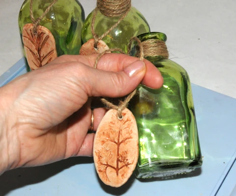 hang clay pendant on herb bottle